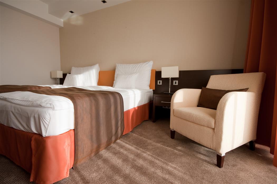 Chambre d'hôtel réalisée avec de la peinture intérieure dans les tons naturels beiges, orangés et sombres